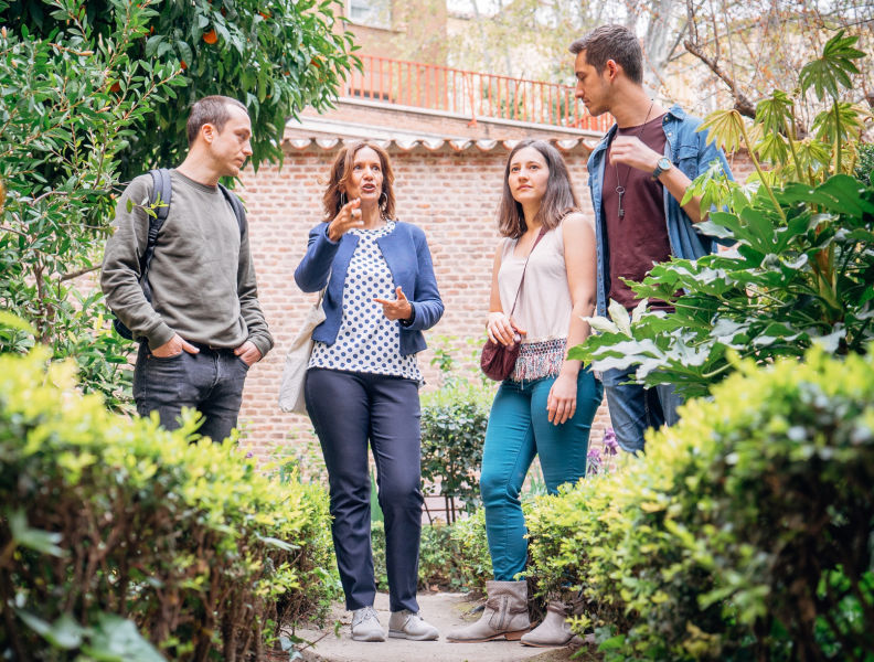 A Context expert guide leading a garden tour