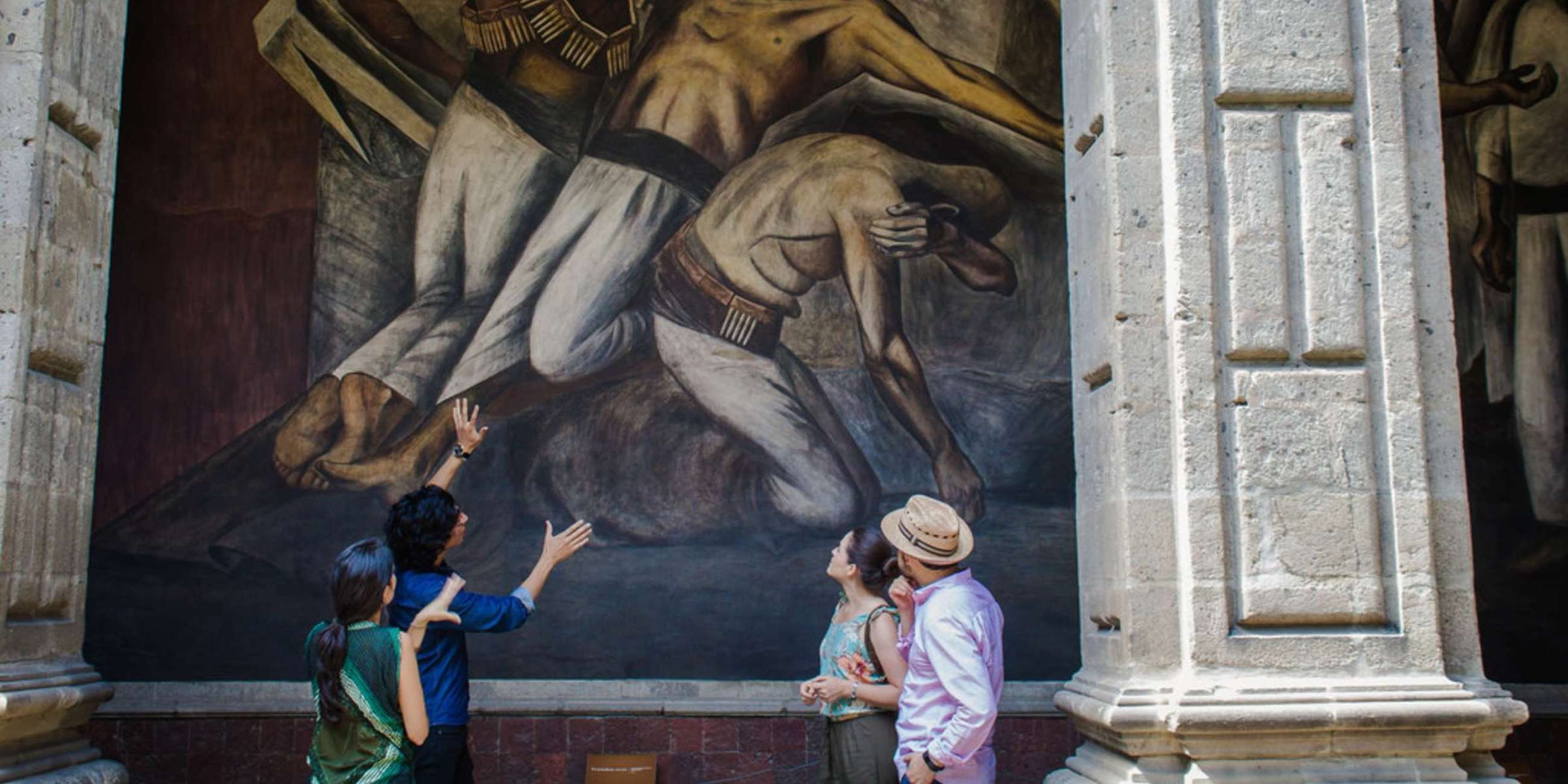 Expert showing mural to guests